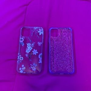 Two clear iPhone 11 cases. One with flowers, the other with purple tint/glitter